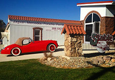 Exterior of LeStable with red convertible parked in driveway